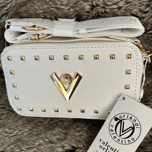 White Valentino Orlandi camera bag with insignia